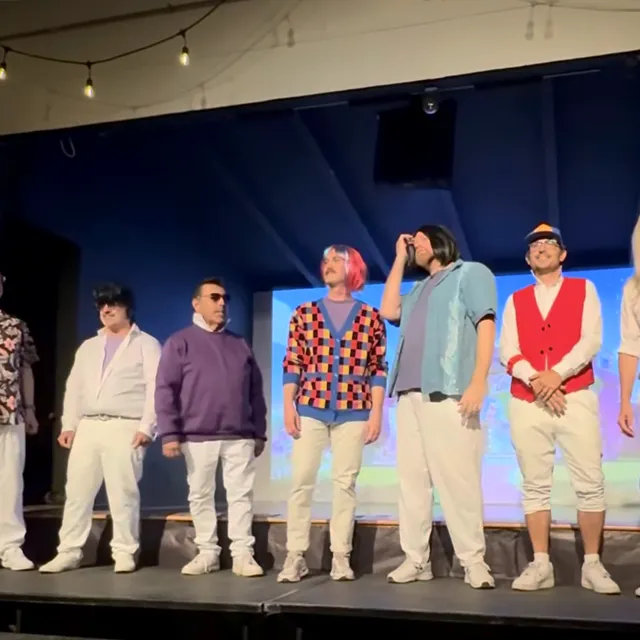 Dads in wigs and 80s outfits on the Follies stage