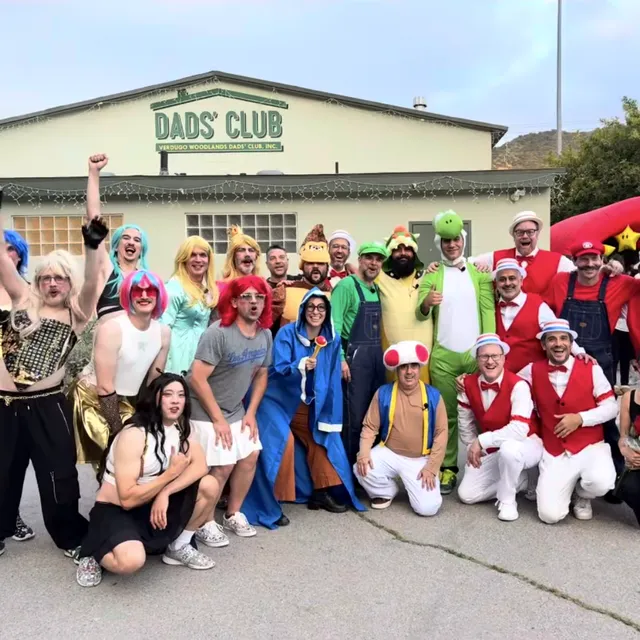 The Fathers' Follies cast in costume outside the clubhouse